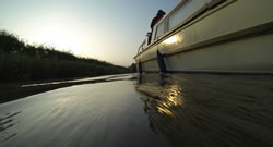 Photo of the side of a canal boat in the Ashby Canal near sunset